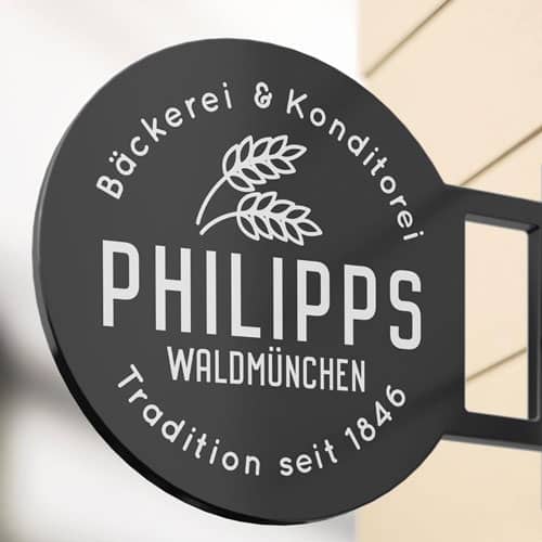 Logo Bäckerei Philips auf schwarzem Schild