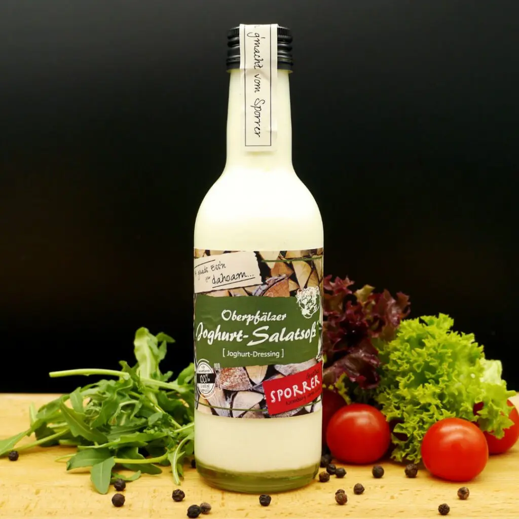 Joghurtsoße in der Flasche auf Salatgarnitur
